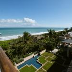 View from the upper balcony of the Orchid Island Beach Club overlooking a garden, the dunes and the Atlantic Ocean