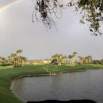 A complete rainbow adorns the sky over Orchid's golf course on a gray day.