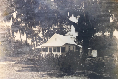 Captain Frank Forster's white, one-story Florida home surrounded by oaks.