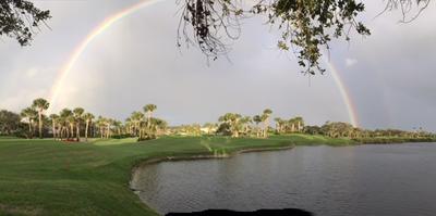 A complete rainbow adorns the sky over Orchid's golf course on a gray day.