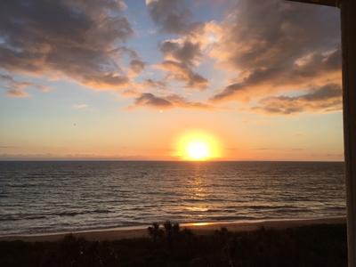 Sunrise with the sun at the horizon over the Atlantic ocean in Orchid.