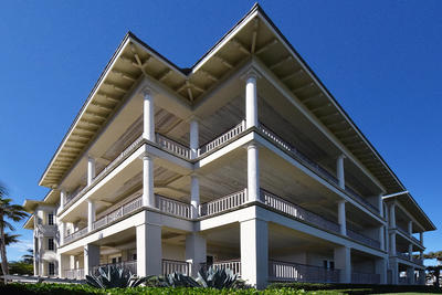 A condominium building photographed from the ground up showing many balconies