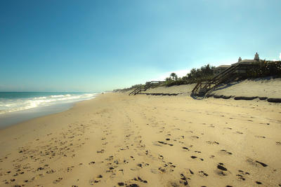 View down the beach along the Atlantic Ocean with dunes and dune crossovers