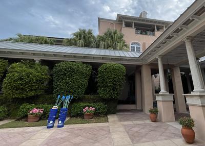 Buckets are stacked with trash pickers in them in front of the Orchid Island Beach Club.