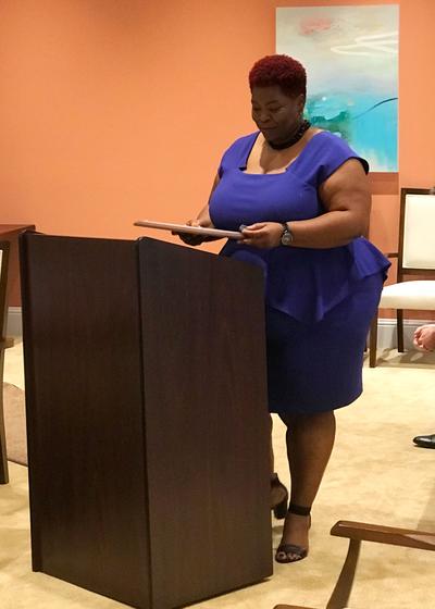 Ms. Lakisha Burch addresses the Town Council from a podium.