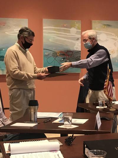 Mayor Gibbons gives former-Mayor Ofstie a gift of a personalized crystal paperweight.